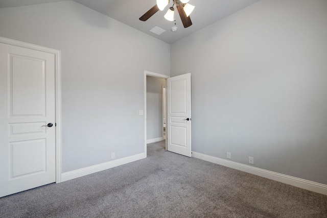 unfurnished bedroom with a ceiling fan, visible vents, vaulted ceiling, baseboards, and carpet floors