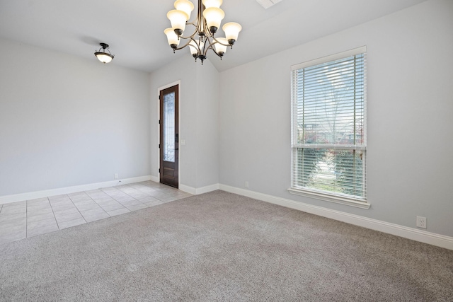 empty room featuring baseboards, light tile patterned floors, a notable chandelier, and light colored carpet