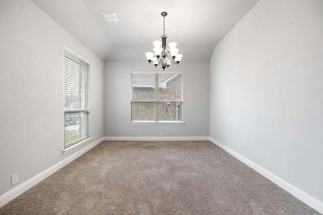 spare room featuring visible vents, a notable chandelier, carpet floors, and baseboards