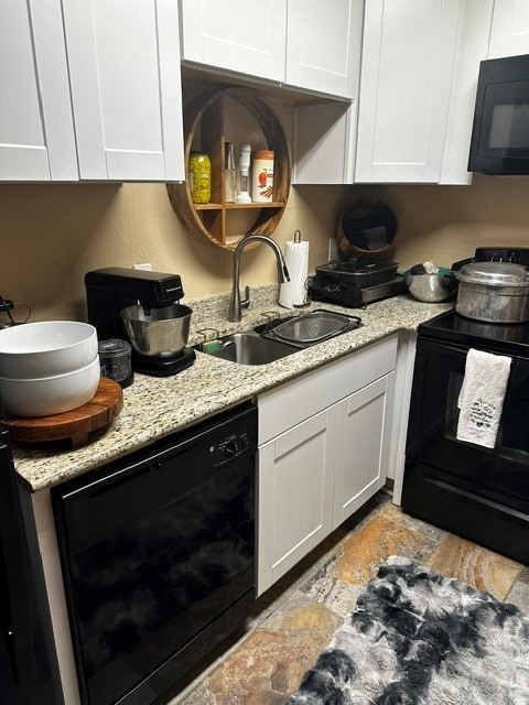 kitchen featuring white cabinetry, sink, and black appliances