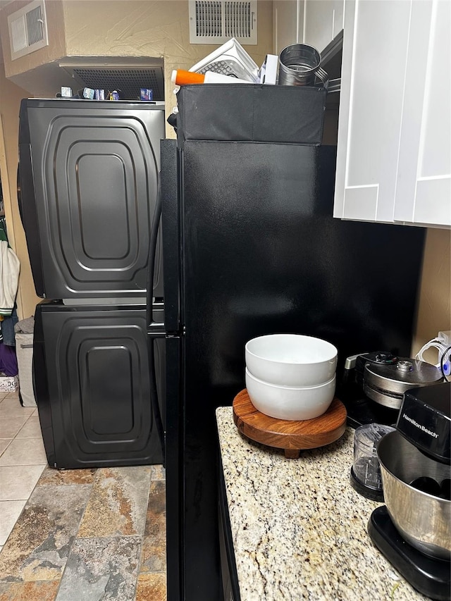 room details featuring stacked washer and clothes dryer