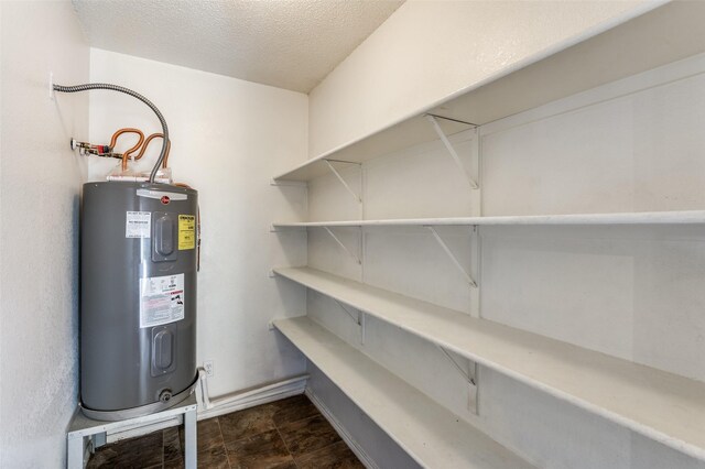 utility room featuring water heater