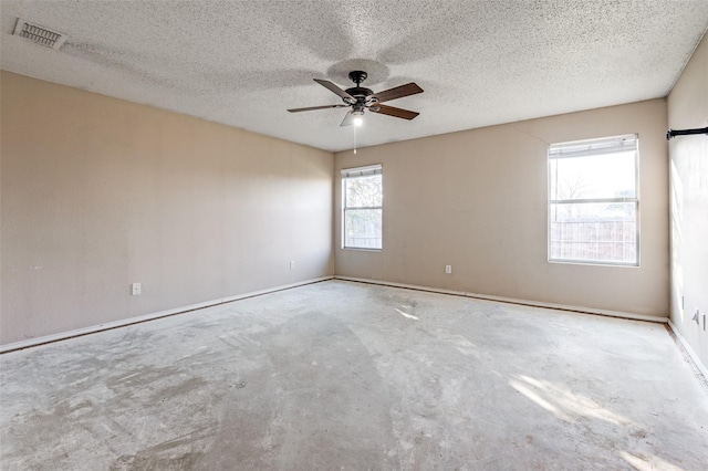 spare room with ceiling fan and a textured ceiling