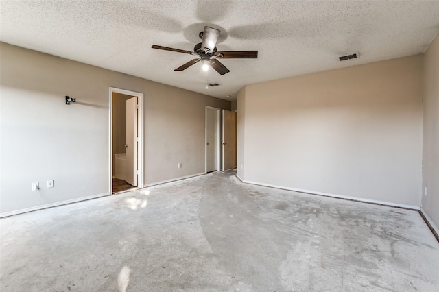 unfurnished room featuring ceiling fan, concrete floors, and a textured ceiling