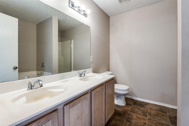 full bathroom featuring independent shower and bath, vanity, a textured ceiling, and toilet