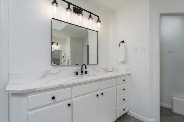 bathroom with vanity, toilet, and tile patterned flooring