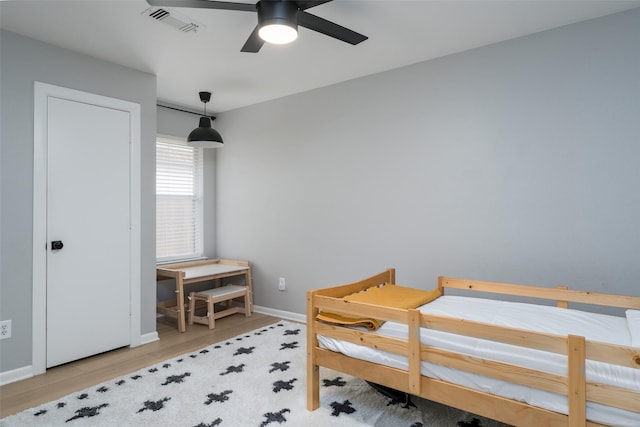 bedroom with ceiling fan and light hardwood / wood-style floors