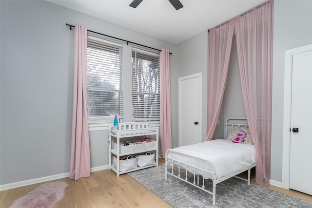 bedroom with light hardwood / wood-style flooring and ceiling fan