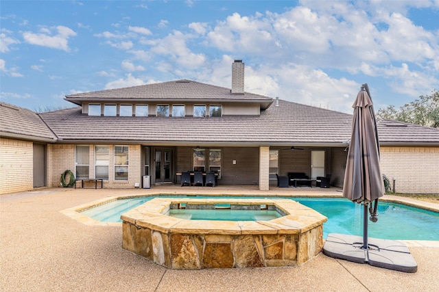 view of swimming pool with an in ground hot tub and a patio