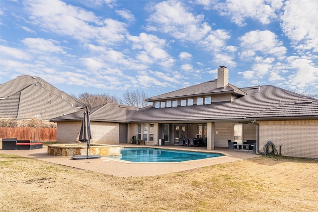 view of swimming pool with a jacuzzi and a patio