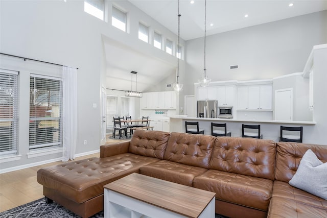 living room with a high ceiling and hardwood / wood-style floors