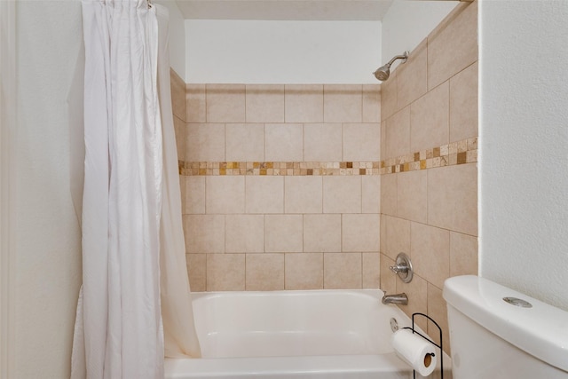 bathroom with shower / tub combo and toilet