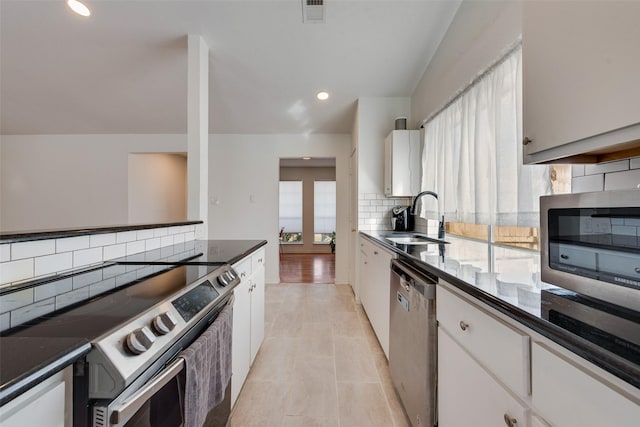 kitchen featuring white cabinetry, sink, and appliances with stainless steel finishes