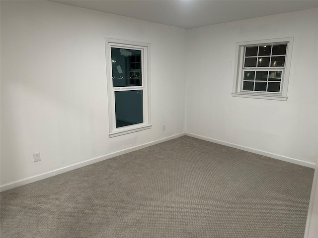 unfurnished room featuring baseboards and carpet floors