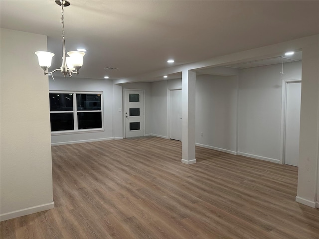 basement with recessed lighting, visible vents, baseboards, and wood finished floors