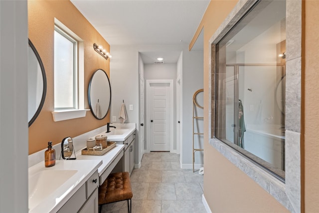 bathroom featuring tile patterned flooring, vanity, and a shower with shower door