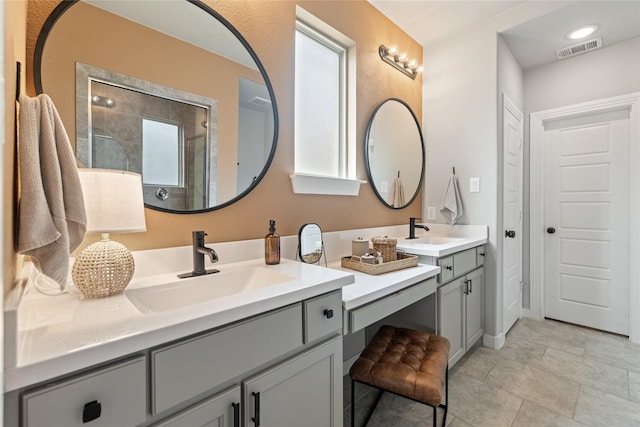 bathroom with vanity and tiled shower