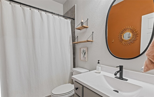 bathroom with vanity, curtained shower, and toilet