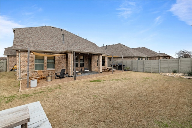 back of property featuring a patio and a yard