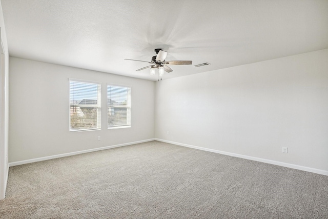 carpeted spare room featuring a textured ceiling and ceiling fan