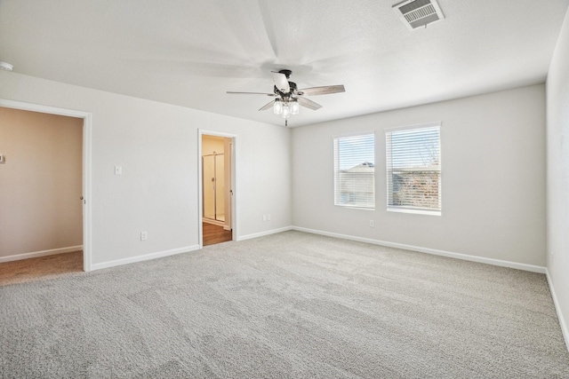 spare room featuring ceiling fan and carpet flooring