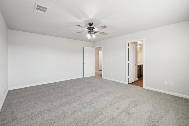 unfurnished bedroom with carpet floors, ceiling fan, and ensuite bathroom