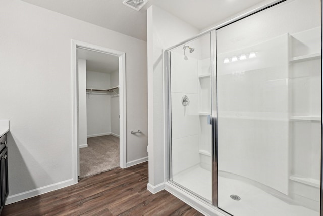 bathroom featuring vanity, hardwood / wood-style floors, and walk in shower