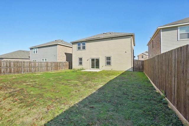 back of house featuring a lawn