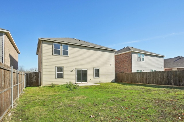 rear view of house with a yard and a patio