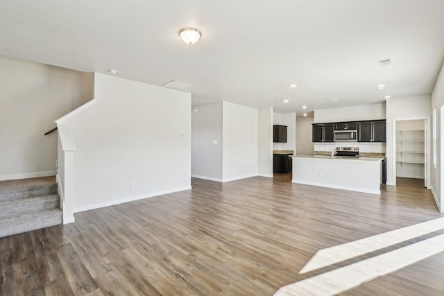 unfurnished living room with wood-type flooring