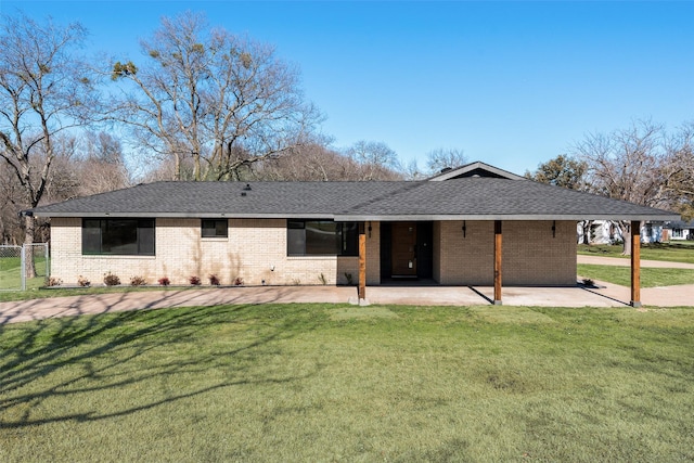 view of front of home with a front yard and a patio