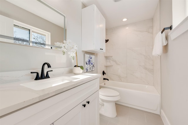 full bathroom featuring tile patterned floors, vanity, toilet, and tiled shower / bath combo