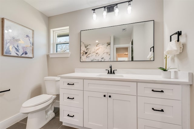 bathroom with tile patterned flooring, vanity, and toilet