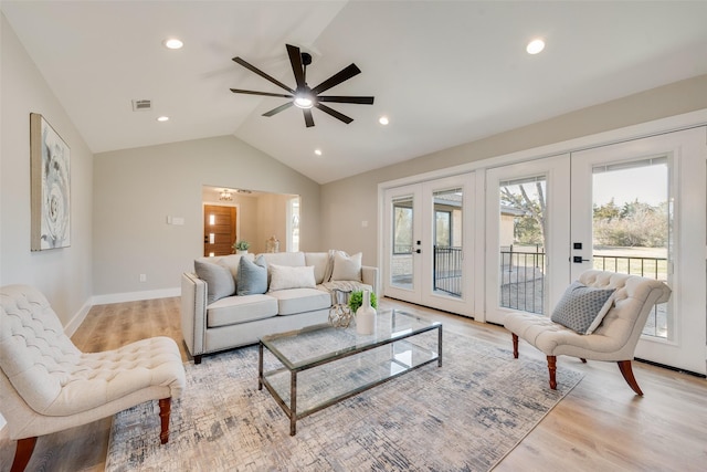 living room with vaulted ceiling, light hardwood / wood-style floors, french doors, and ceiling fan