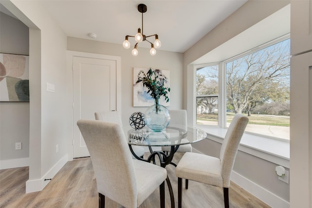 dining room with a chandelier and light hardwood / wood-style floors