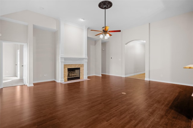 unfurnished living room with hardwood / wood-style flooring, vaulted ceiling, and ceiling fan