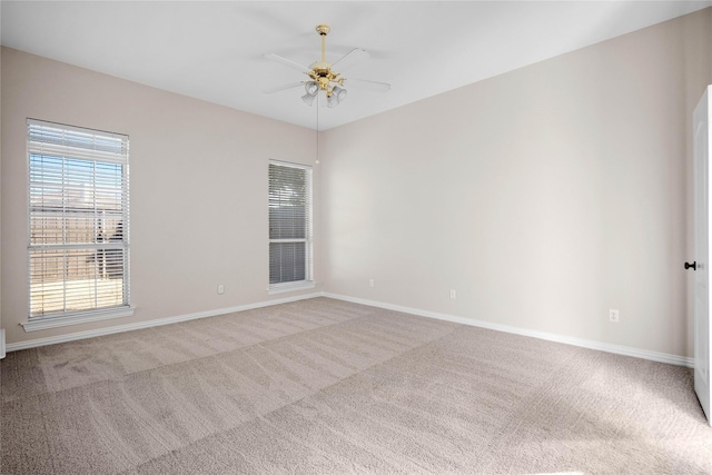 empty room with light colored carpet and ceiling fan