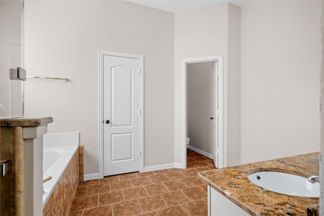 bathroom with vanity, toilet, and a bathing tub