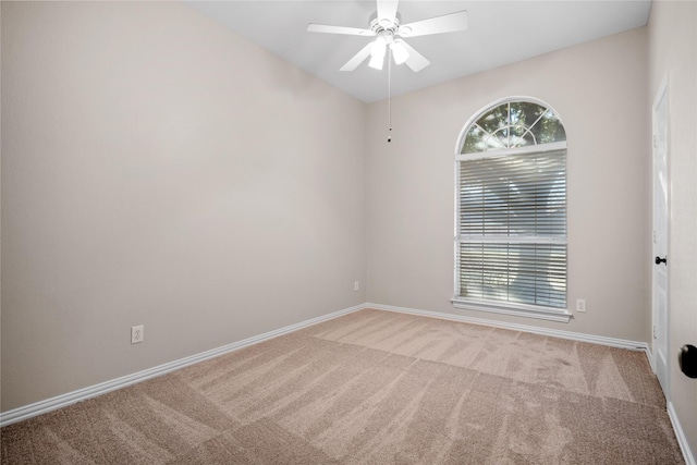 carpeted spare room with a healthy amount of sunlight and ceiling fan