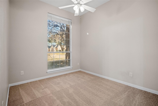 carpeted spare room featuring ceiling fan