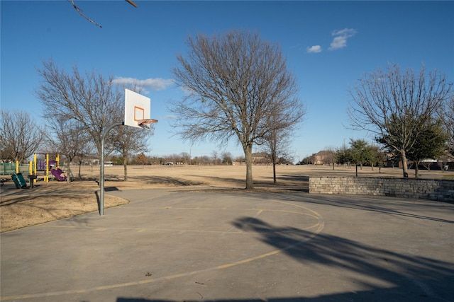 view of sport court featuring a playground