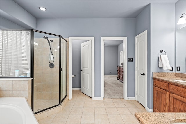 bathroom featuring independent shower and bath, vanity, and tile patterned floors