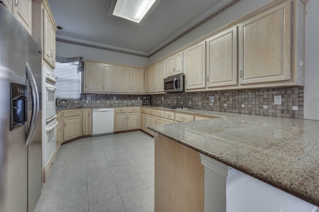 kitchen featuring stainless steel appliances, light brown cabinetry, light stone countertops, and kitchen peninsula