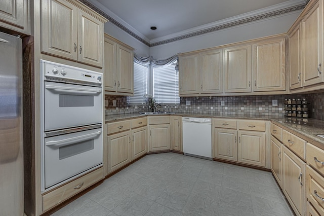 kitchen with sink, white appliances, decorative backsplash, and light brown cabinets