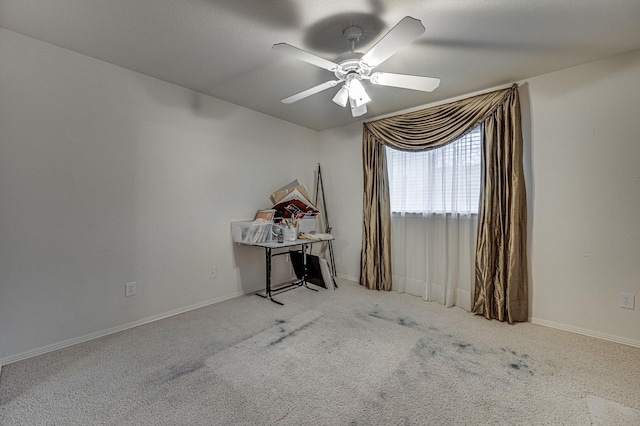 unfurnished room with light colored carpet and ceiling fan