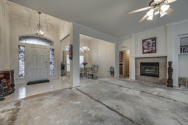 foyer entrance featuring crown molding and ceiling fan with notable chandelier