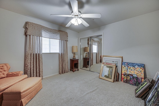 sitting room with light colored carpet and ceiling fan