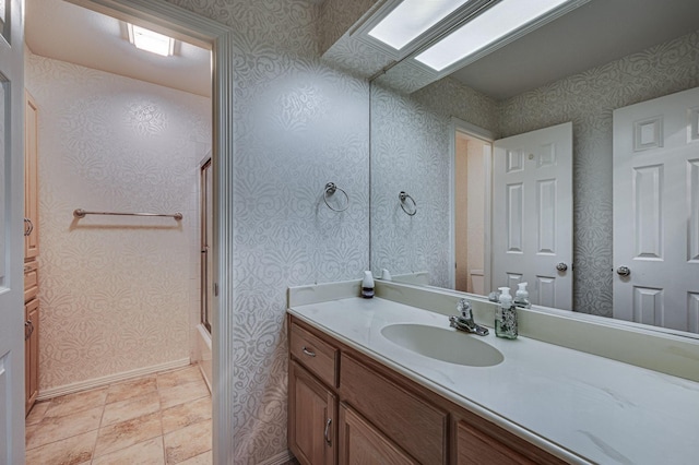 bathroom featuring vanity and combined bath / shower with glass door