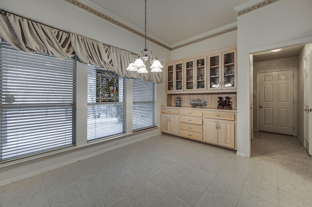 unfurnished dining area featuring crown molding and a chandelier