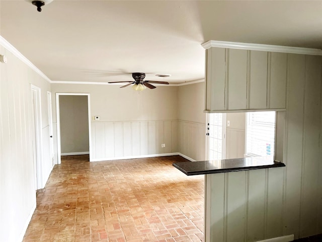 empty room with ornamental molding and ceiling fan